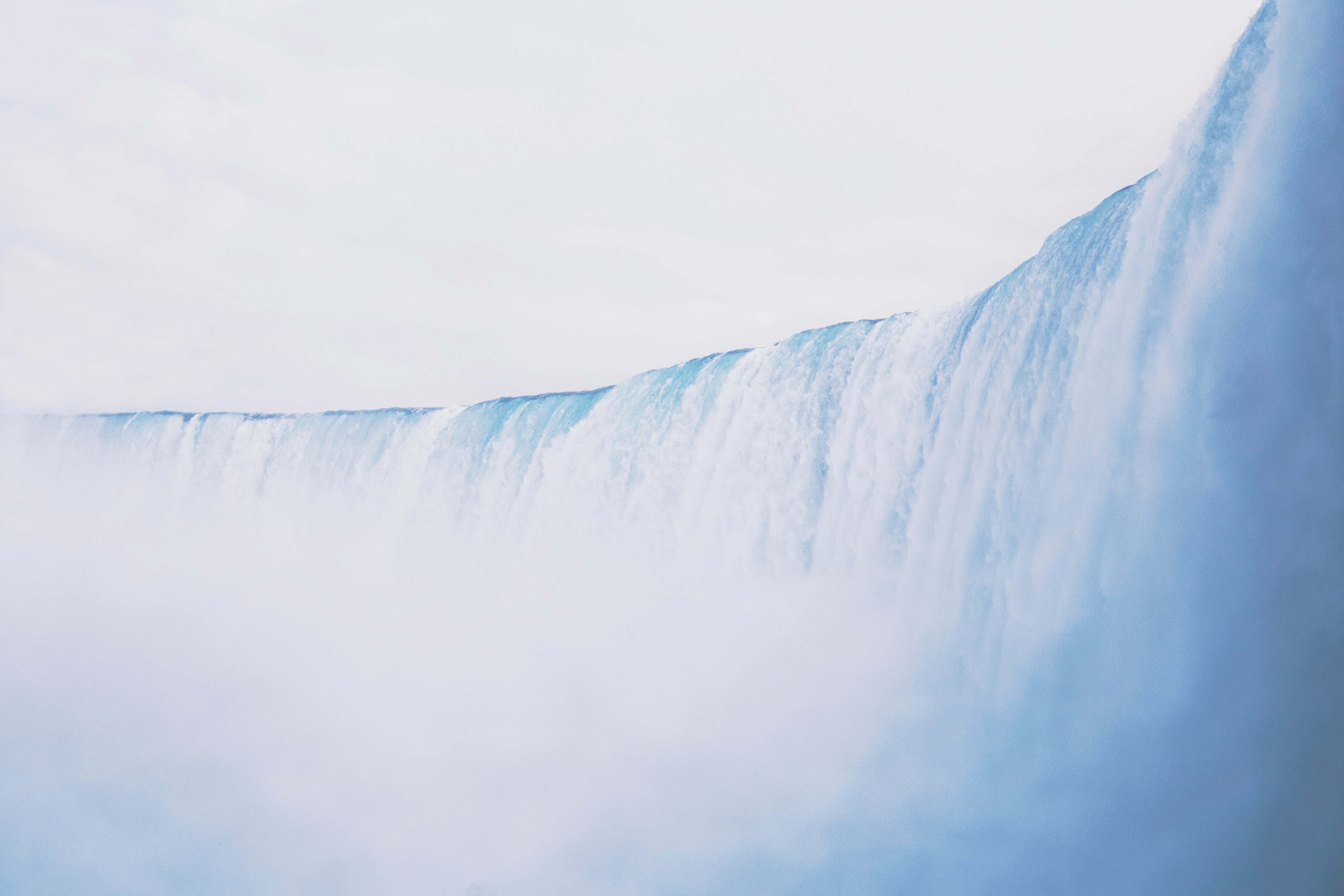 waterfalls under cloudy skies